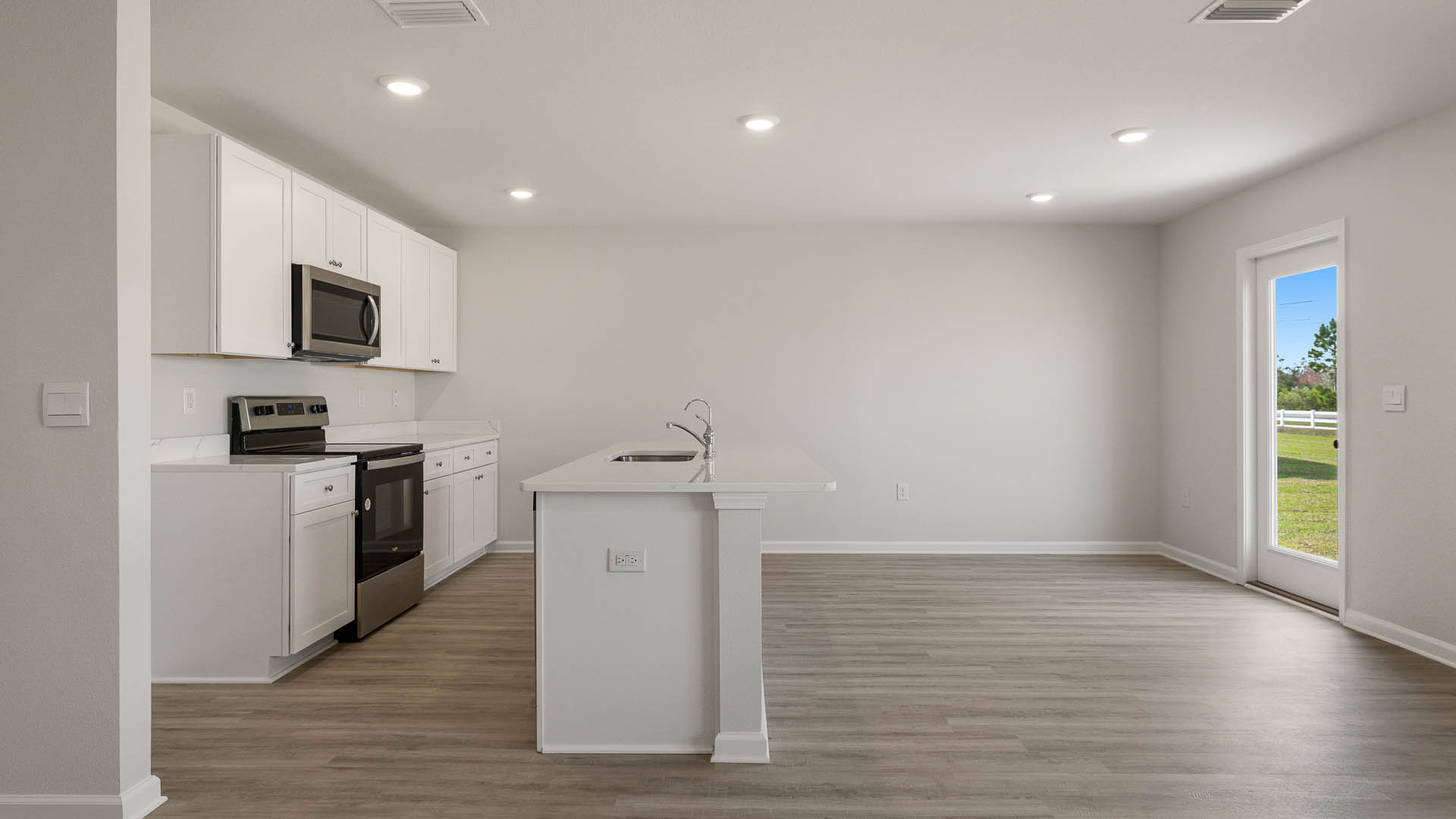 The kitchen has a center islanding that looks out to the open concept living space