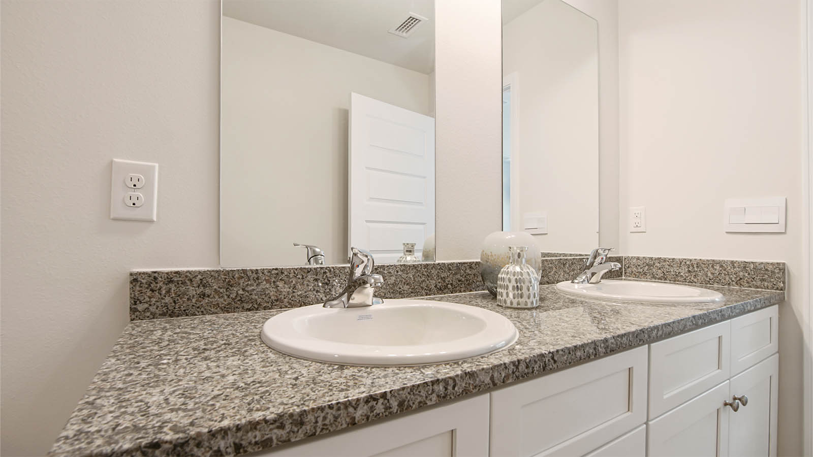 The dual sink vanity has single mirrors over each basin