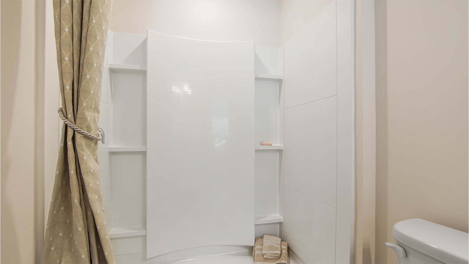 Step in fiberglass shower in the primary bathroom