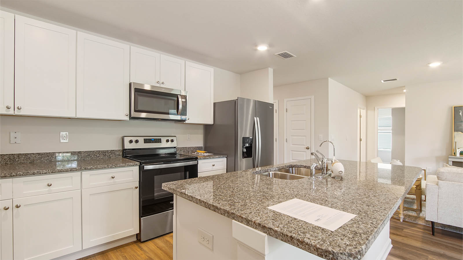 The kitchen has a center island with sink and dishwasher