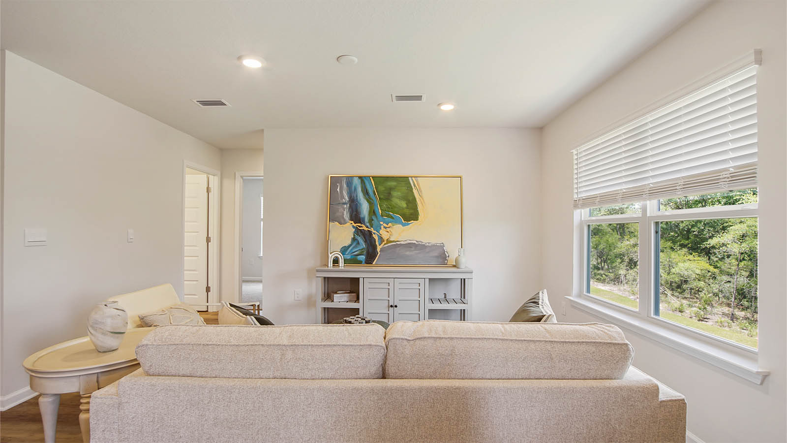 The living area opens to a hall leading to bedrooms two and three