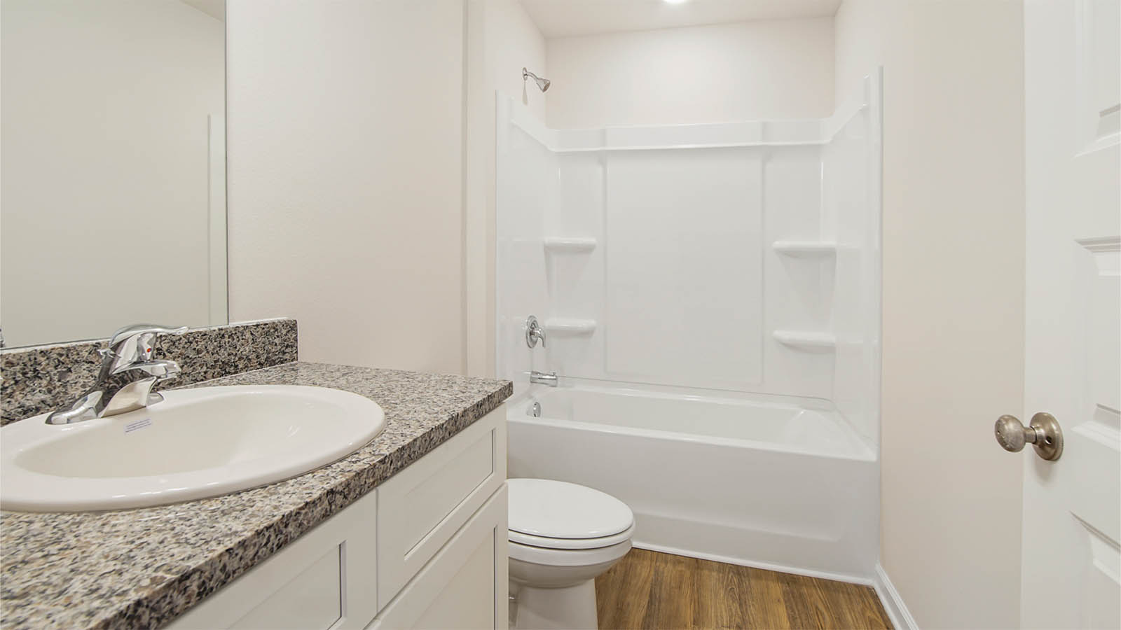 The guest bedrooms share a full bath with vanity and shower tub combination