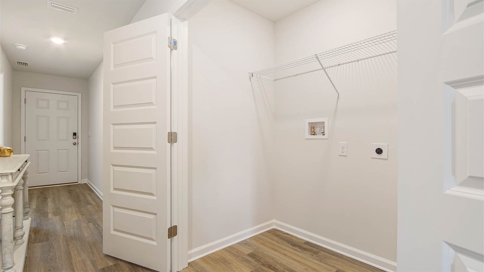 The laundry area is located off the entry hall leading to the living area
