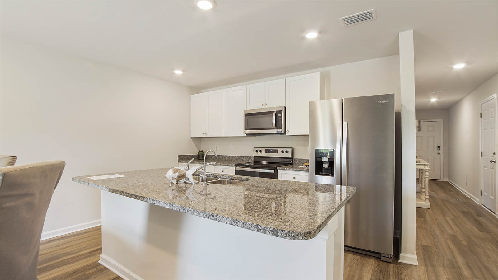 Kitchen with granite countertops and white cabinetry