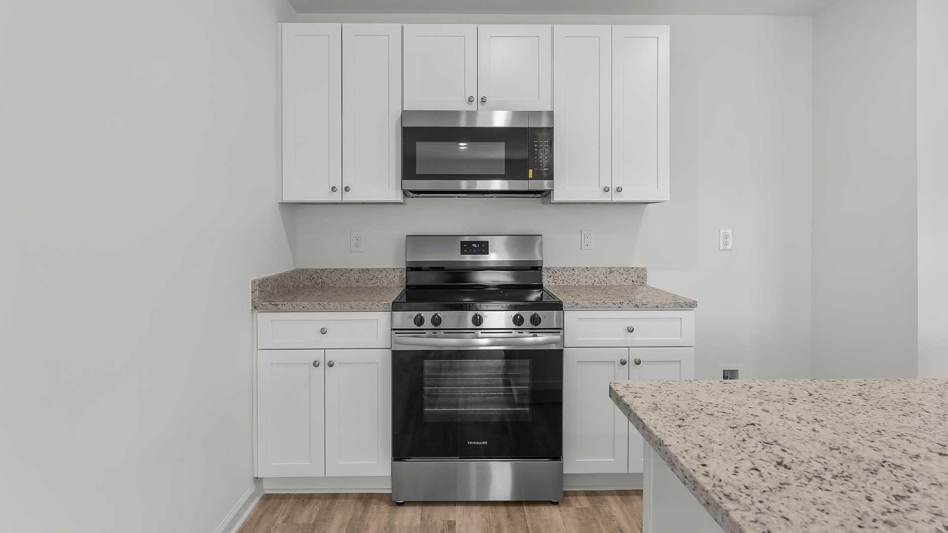 The kitchen has a standard appliance package that includes a smooth top stove, microwave and dishwasher