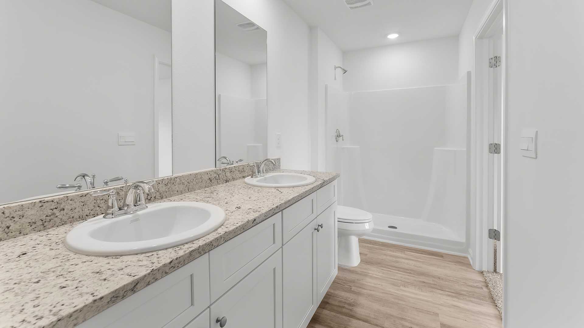 The primary bath has a shower and walk in closet