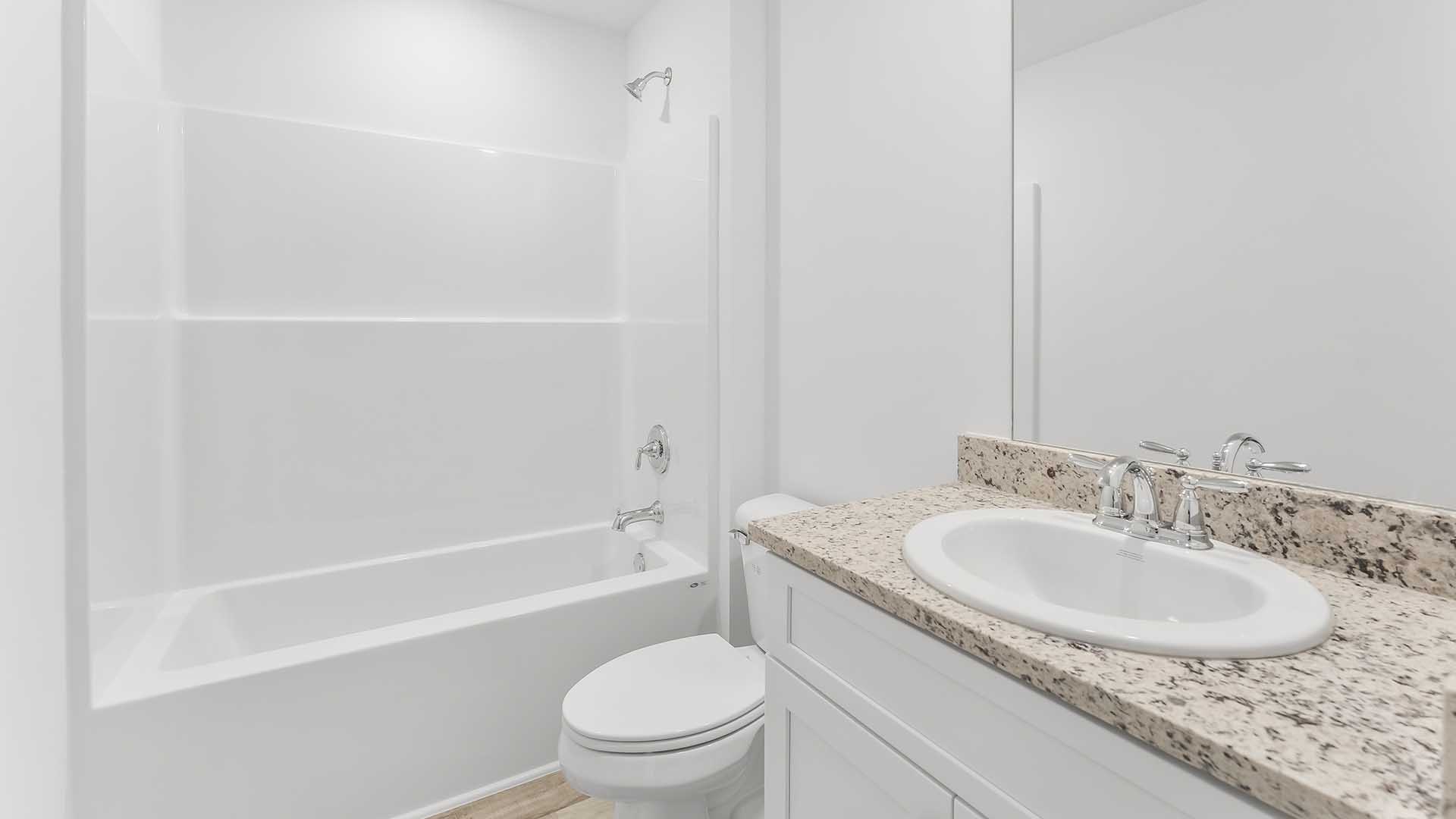 The second bathroom is located between bedrooms two and three. It has a single vanity and shower tub combination