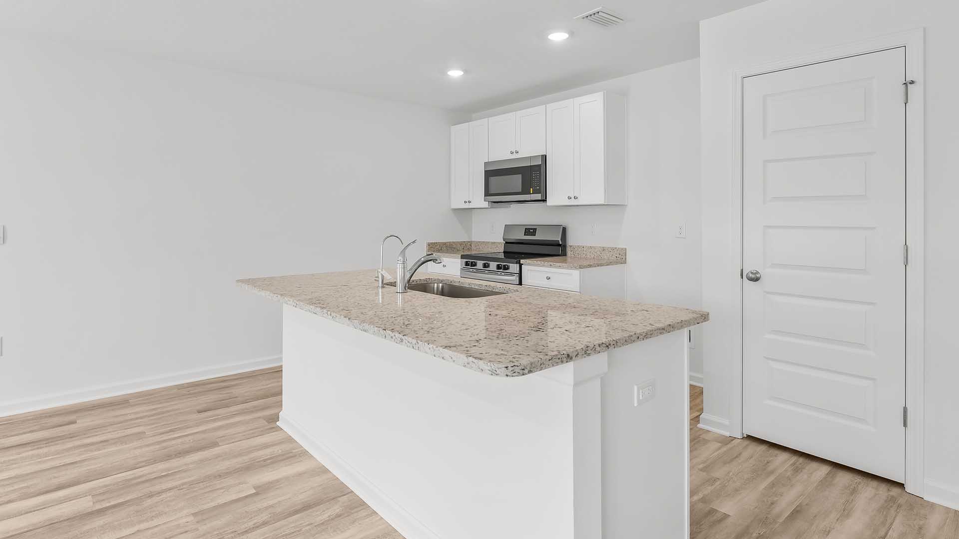 The entry hall leads to an open kitchen and living area