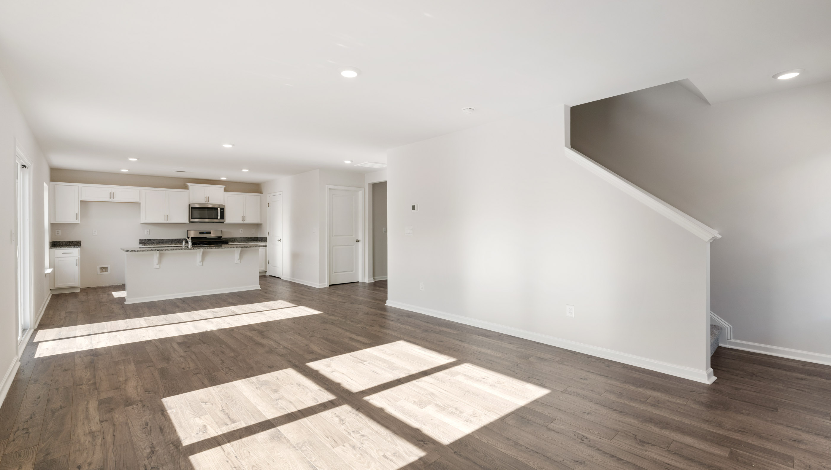 The open living space can hold a casual dining area and living room suite