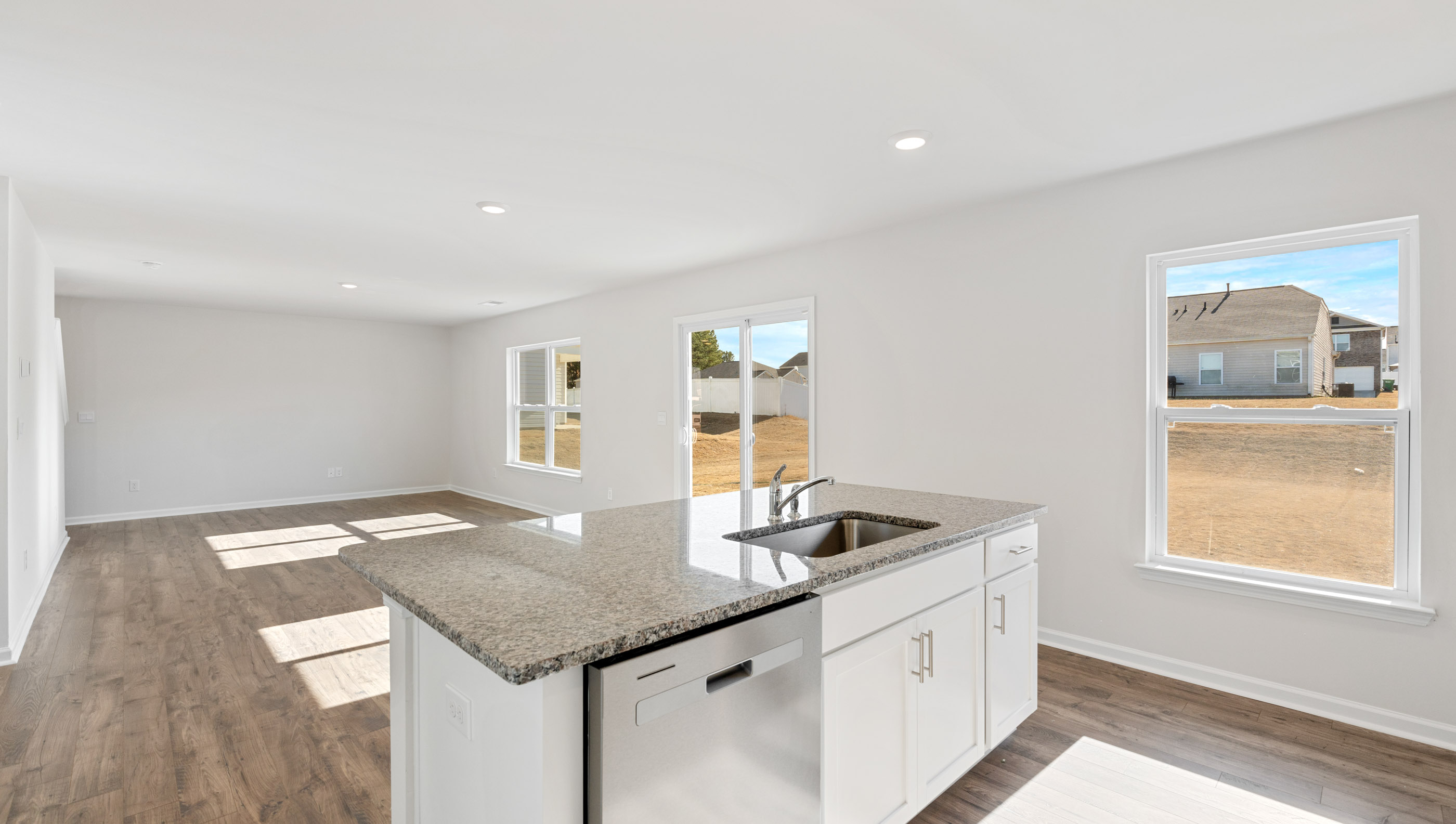 The kitchen looks out to the open great room