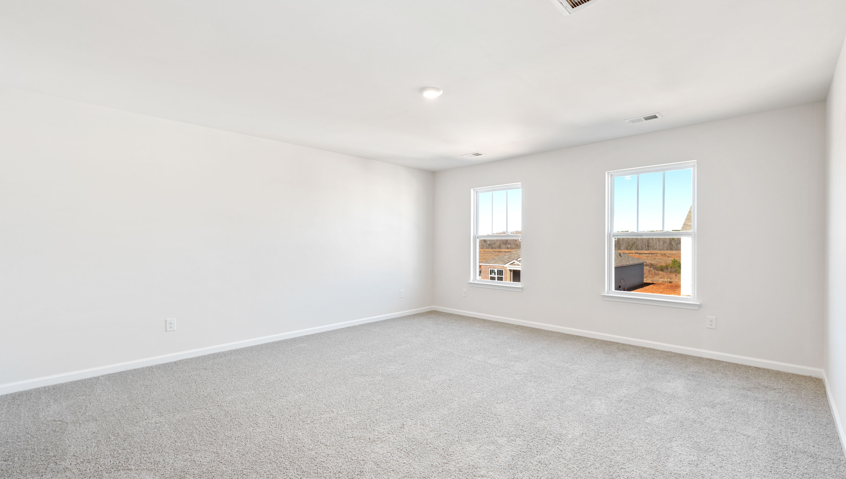 One of three guest bedrooms is large and situated overlooking the front of the home