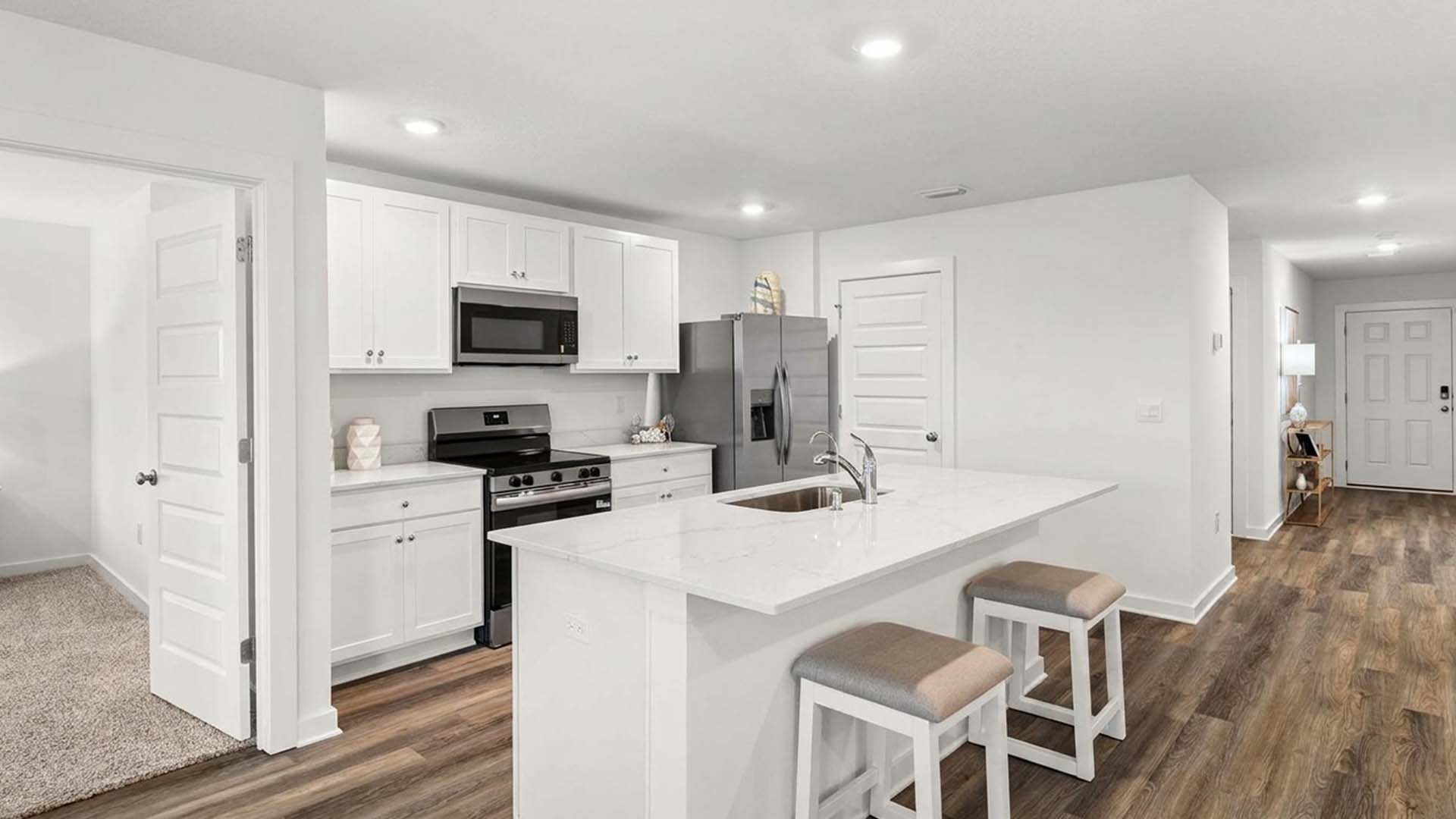 The center island has quartz countertops and space for bar seating