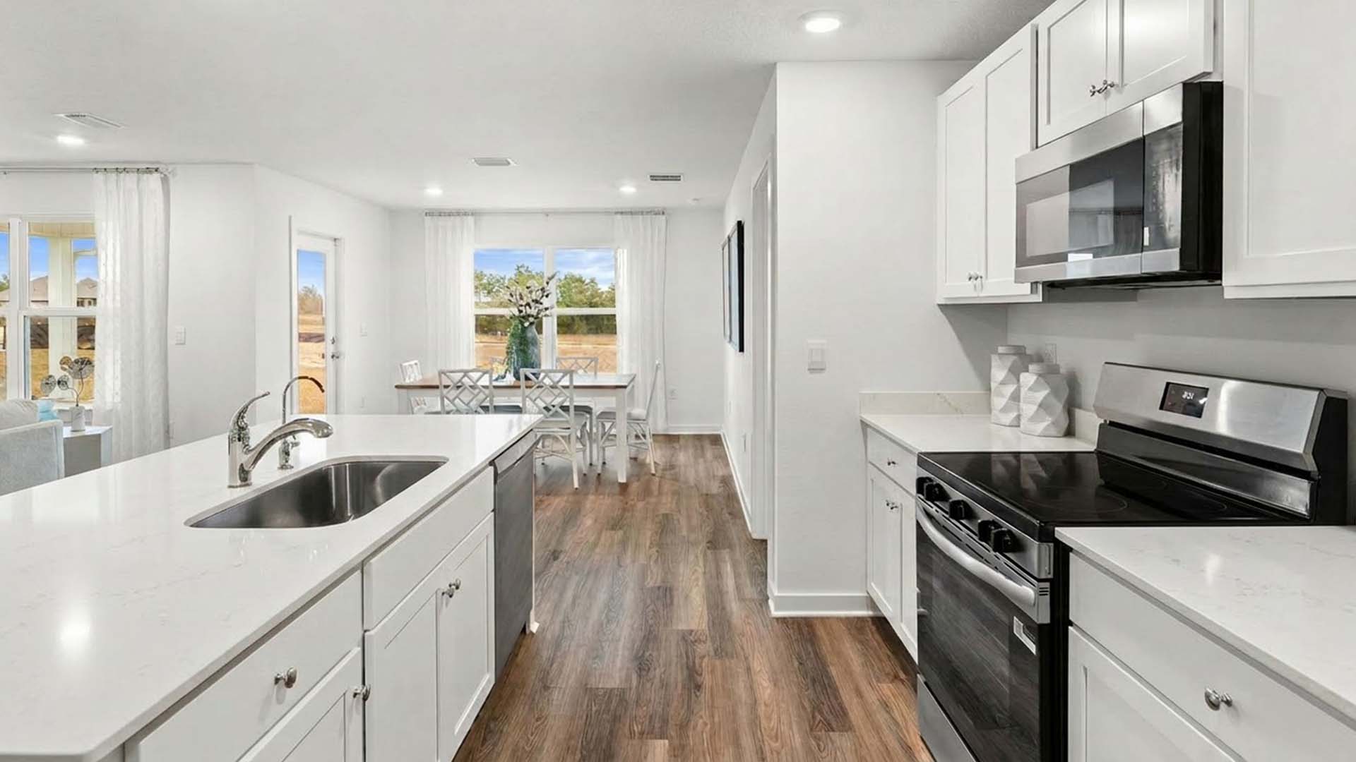 This kitchen has appliances including a smooth top stove, microwave and dishwasher
