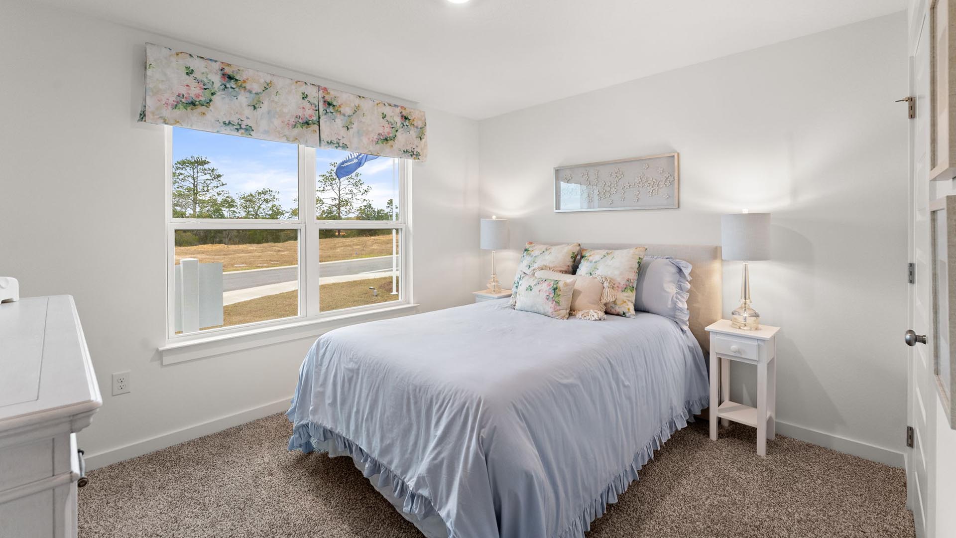 Guest bedroom two is located at the front of the home with a large picture window
