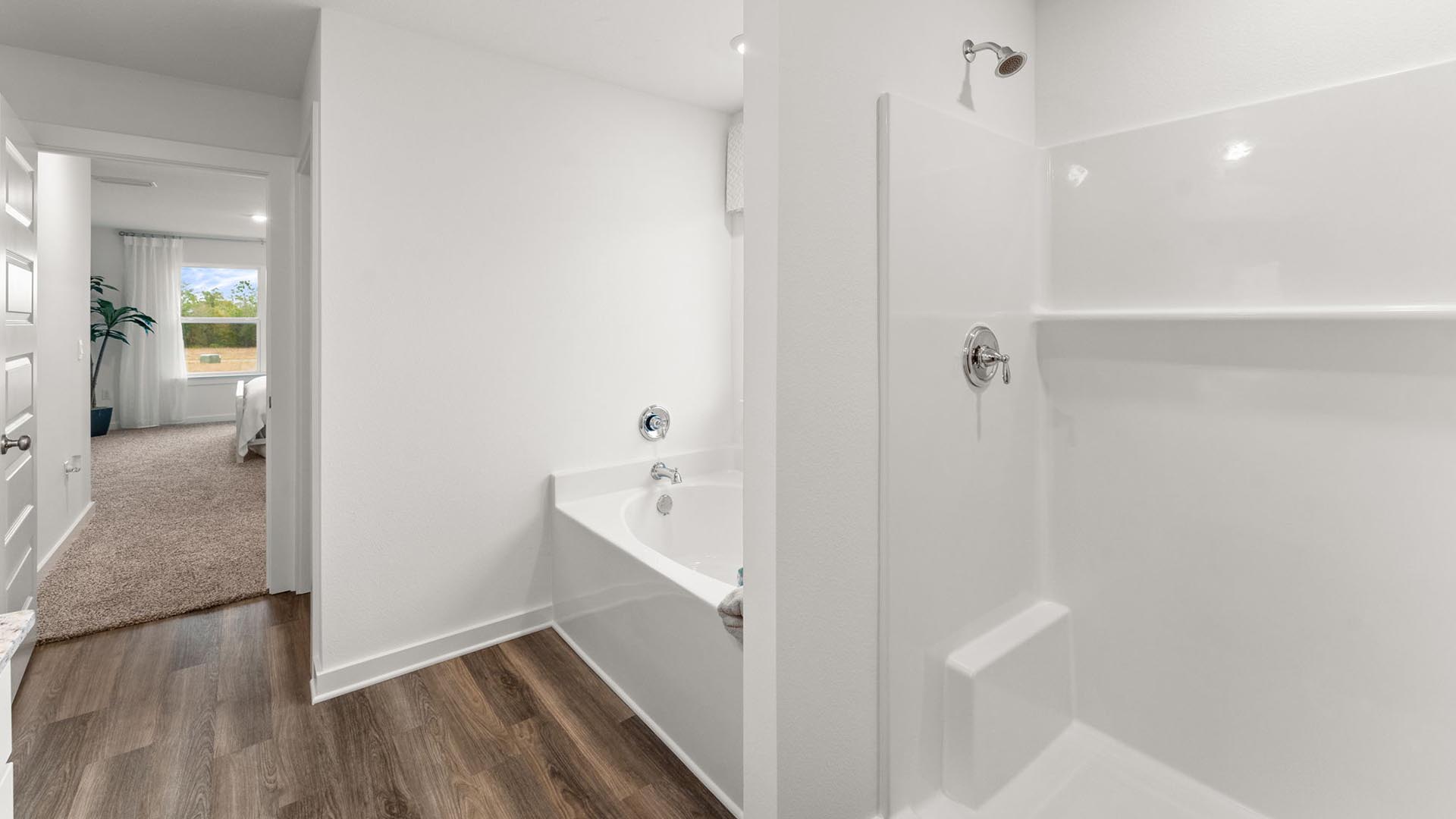 The open shower is thoughtfully designed with proper drainage and placement to balance style, comfort and functionality