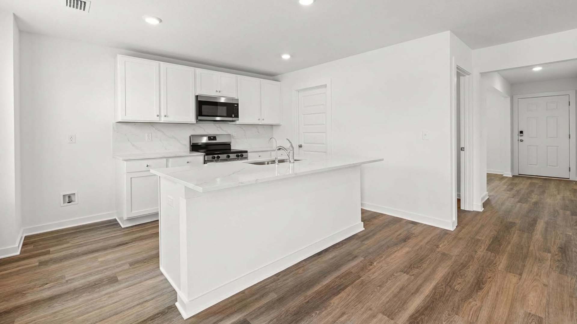 The kitchen has a center island with lower cabinetry