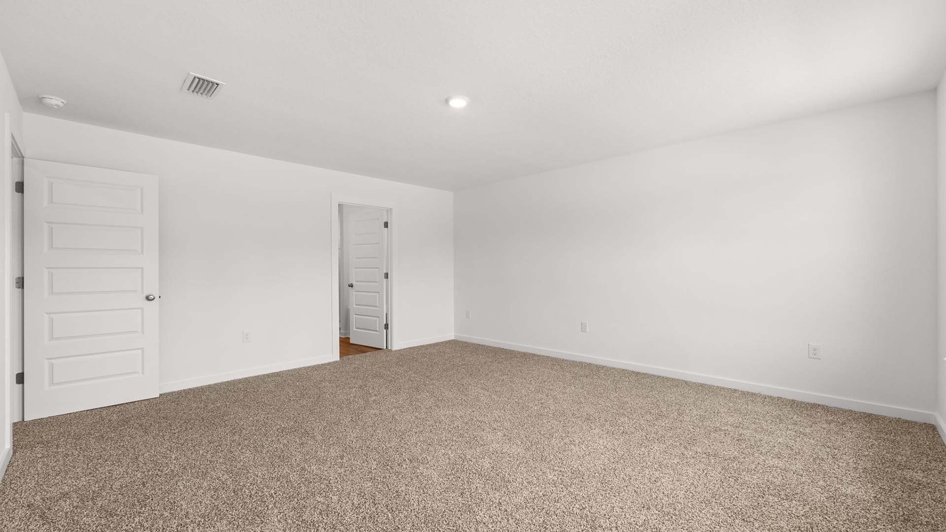 One of three guest bedrooms is large and situated overlooking the front of the home