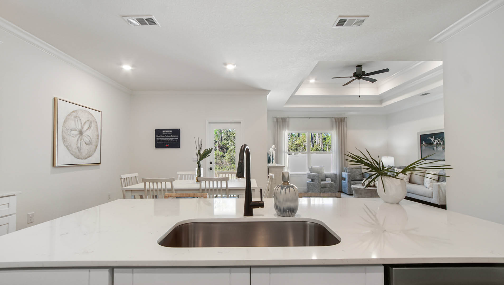 Large center island with quartz countertops and sleek black plumbing fixtures