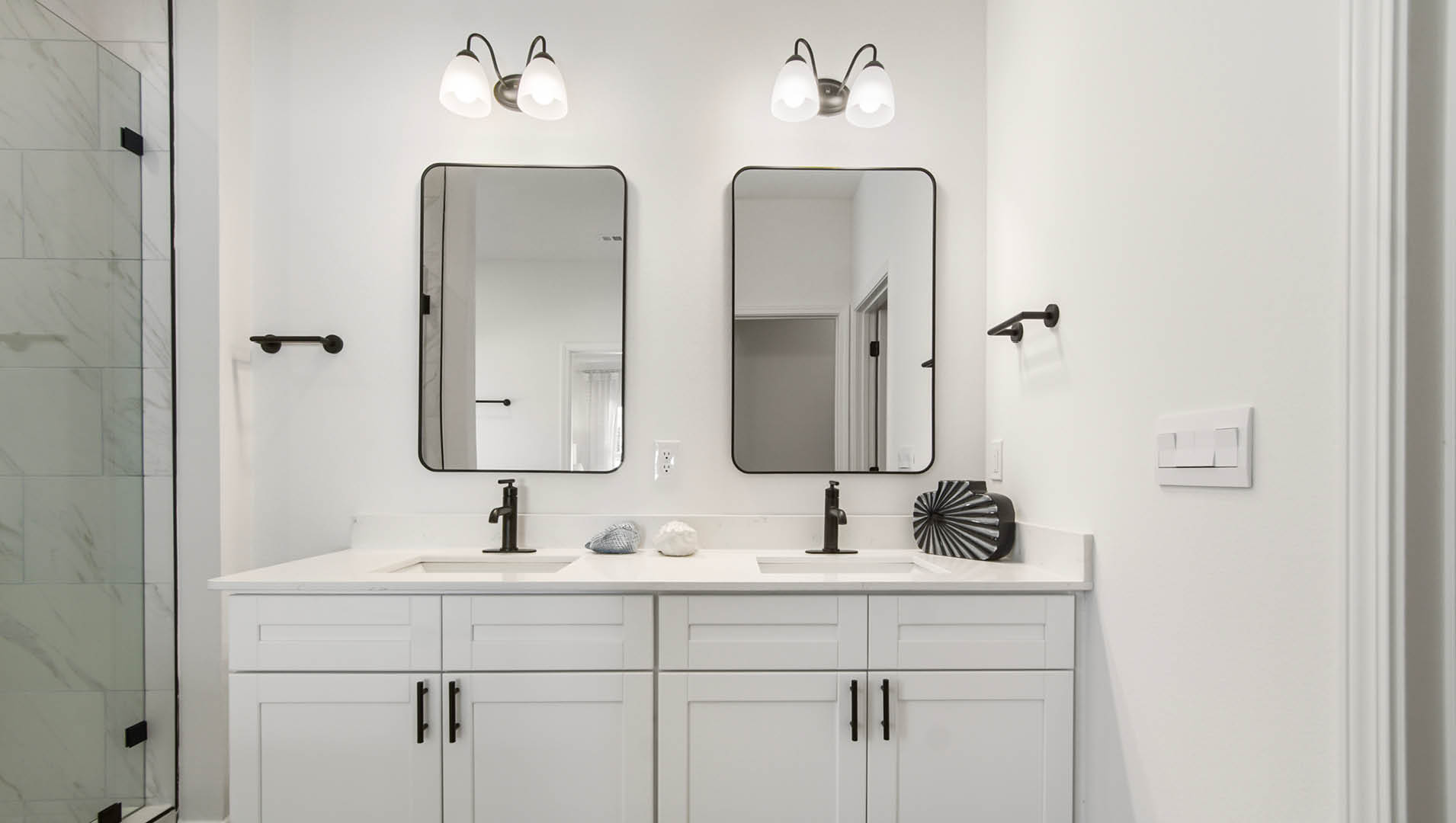 Primary bathroom is elegantly appointed with EVP flooring quartz countertops and a dual sink vanity with single mirror over each sink