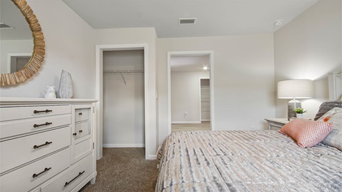 Bedroom four is located off a small hall near off the garage and by the laundry room