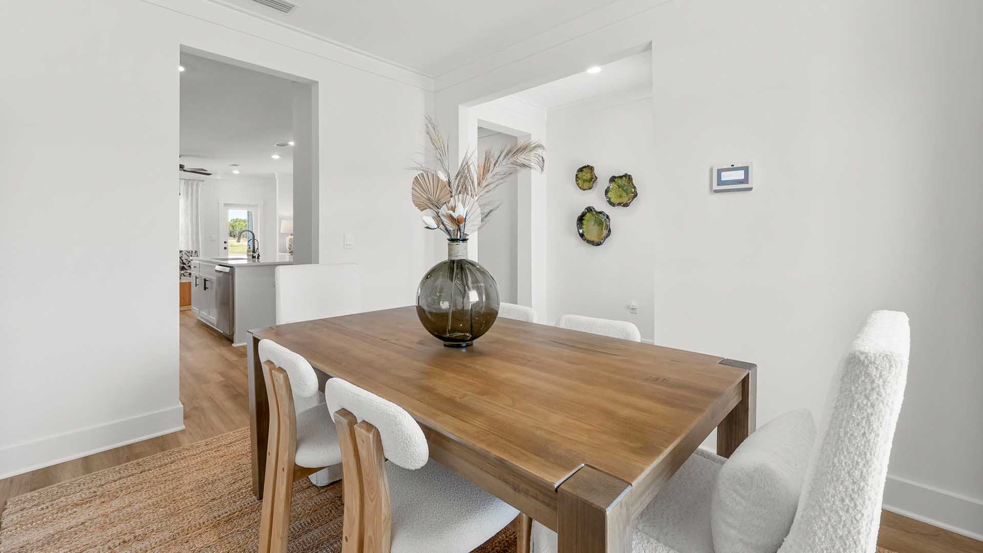 The dining room features EVP flooring and windows allowing for natural light