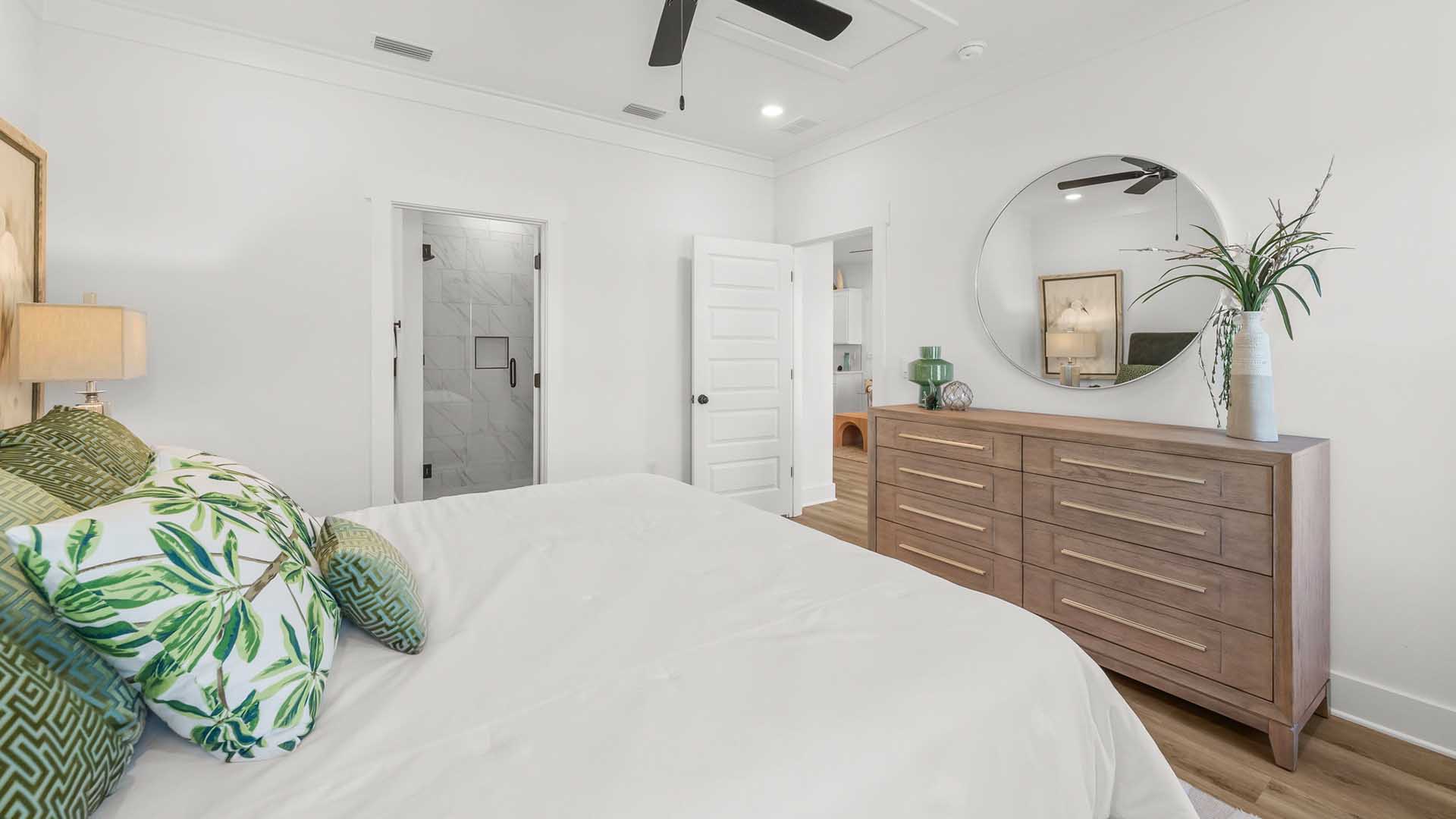 The Primary bedroom has EVP flooring and features a ceiling fan