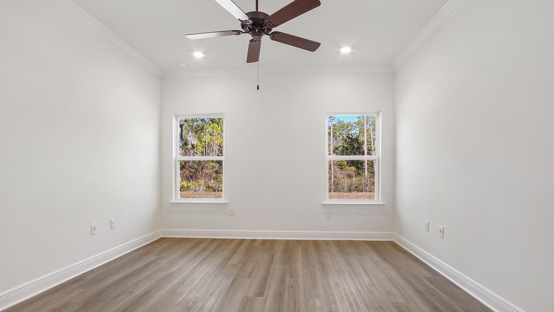 The Primary bedroom has EVP flooring and features a ceiling fan