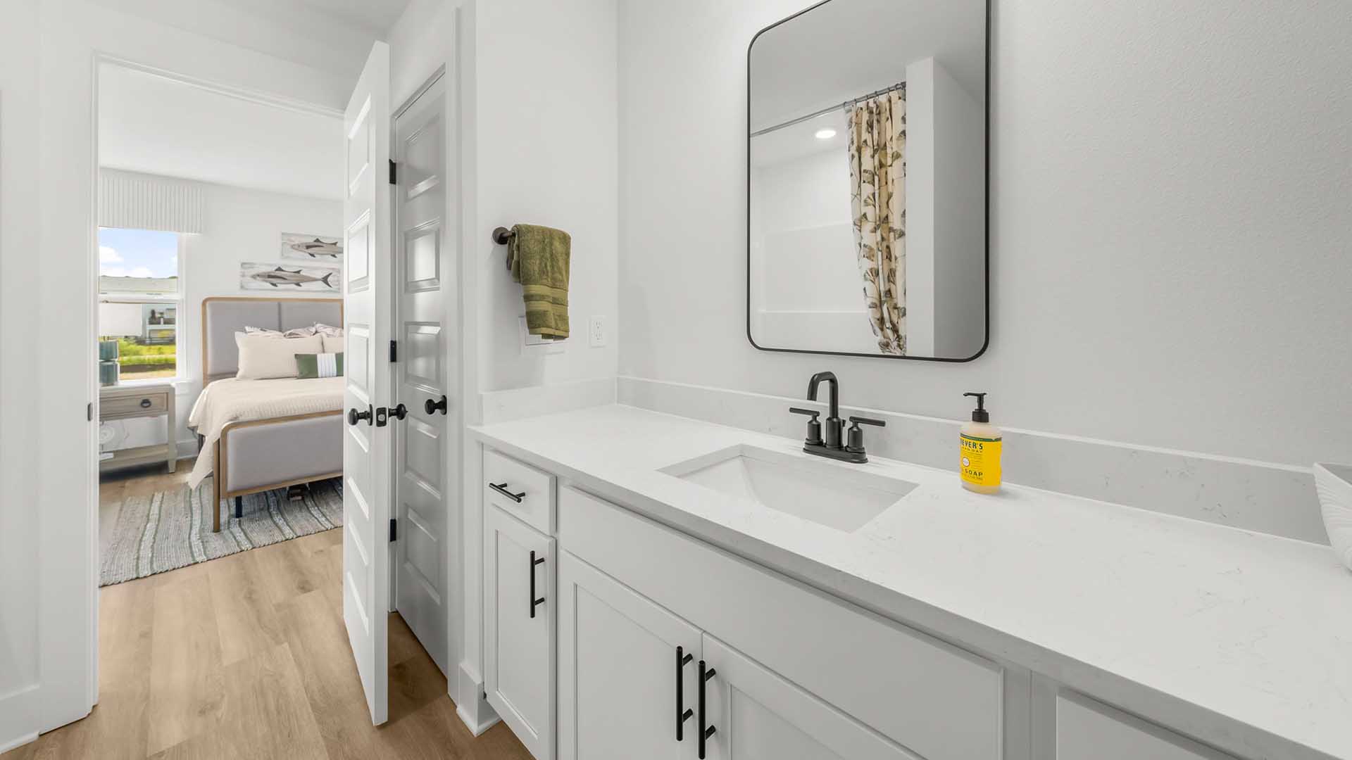 Private bathroom of Bedroom two with vanity and lower cabinetry for storage