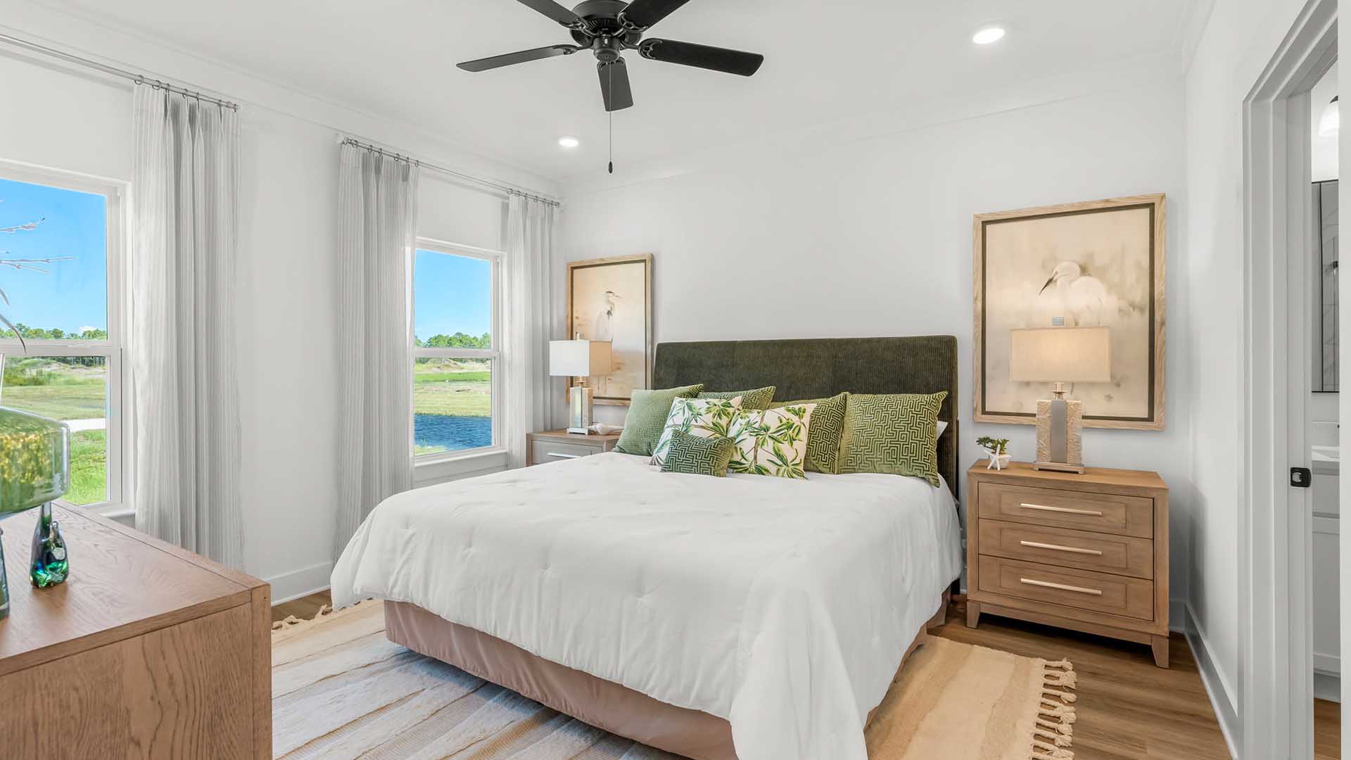 The primary bedroom is located on the main level and has a ceiling fan