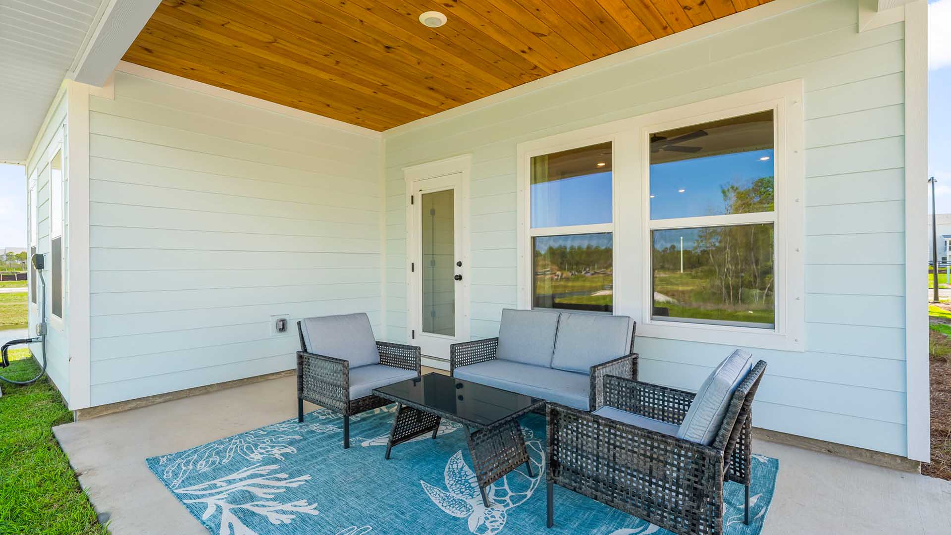 The back of the home has a covered patio accessible from the living area