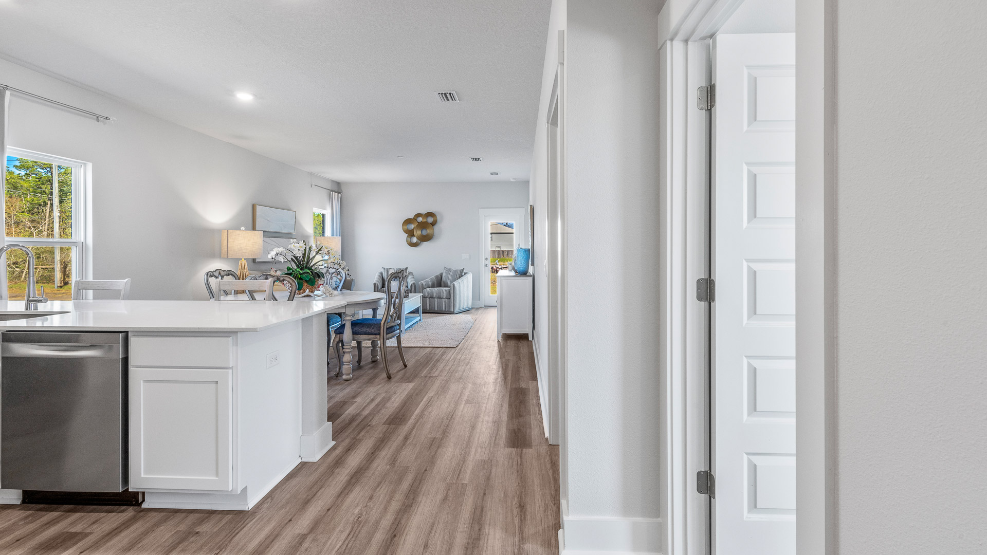 The open concept living area features a seamless transition between the kitchen, living and dining areas