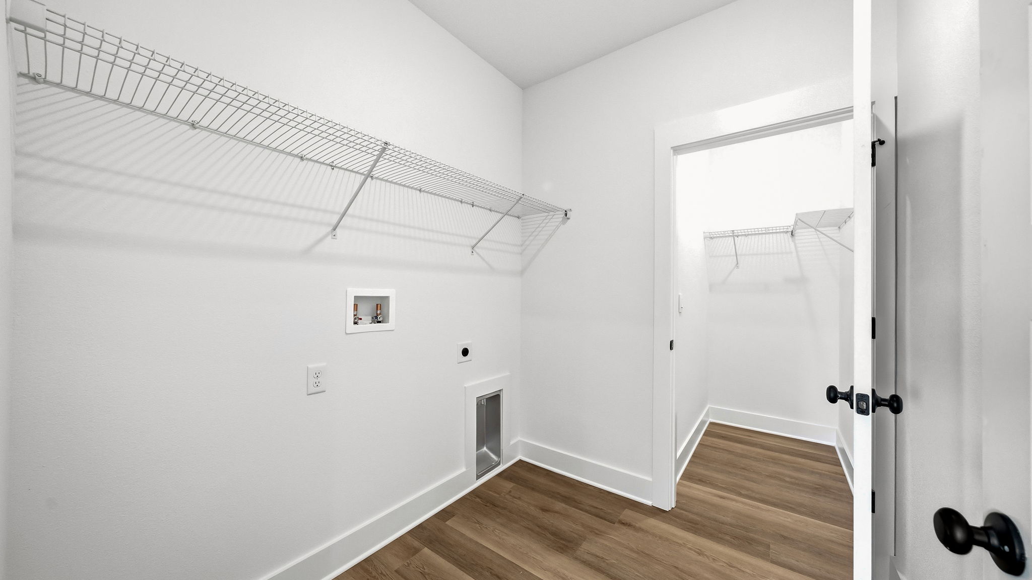 The laundry room has space for a full size washer and dryer