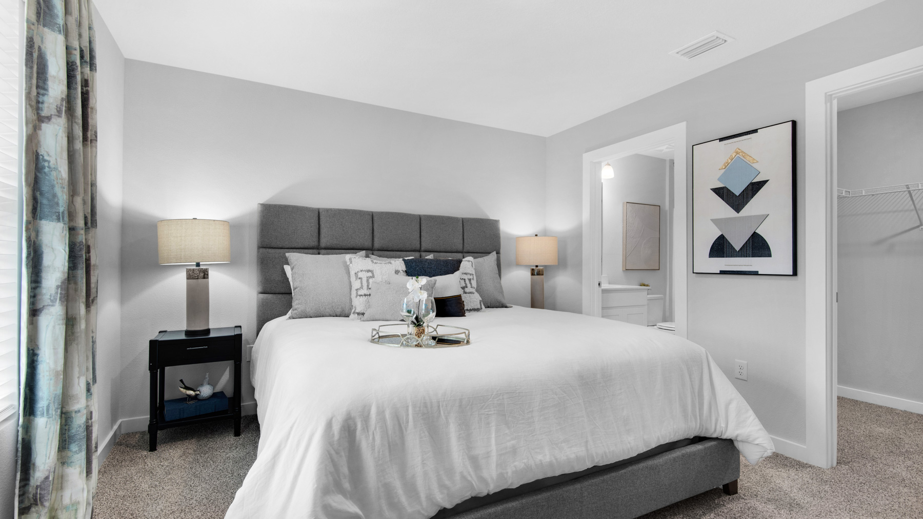 The primary bedroom is tucked away at the back of the home for privacy