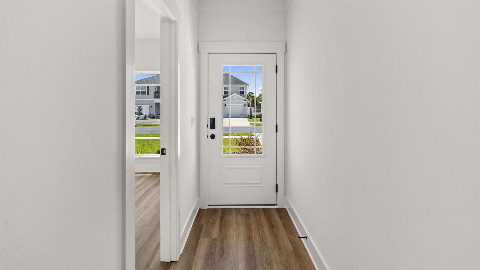 The entry hall has EVP flooring and two guest bedrooms as you head towards the living area