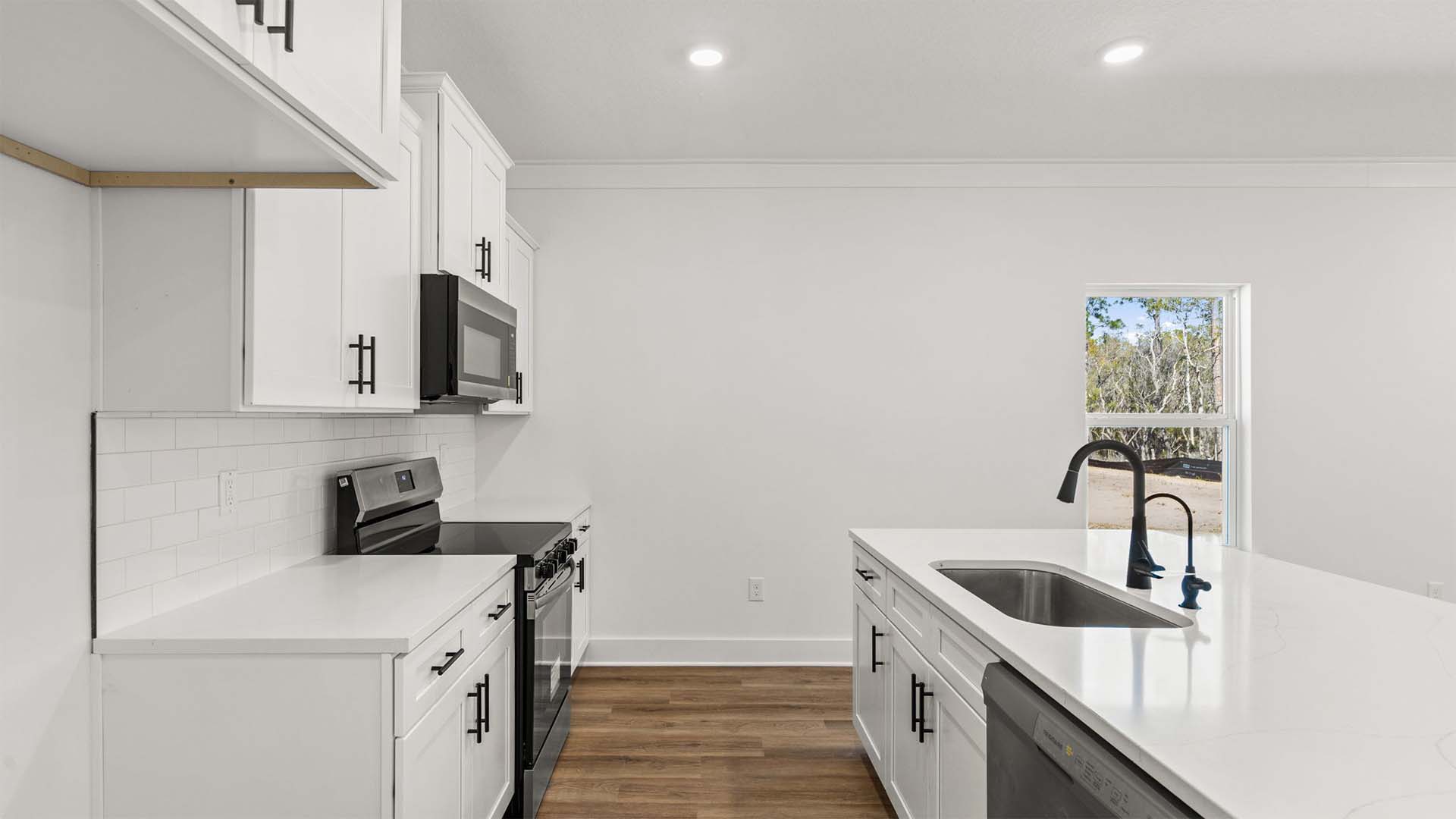 The kitchen has upper and lower cabinetry for storage