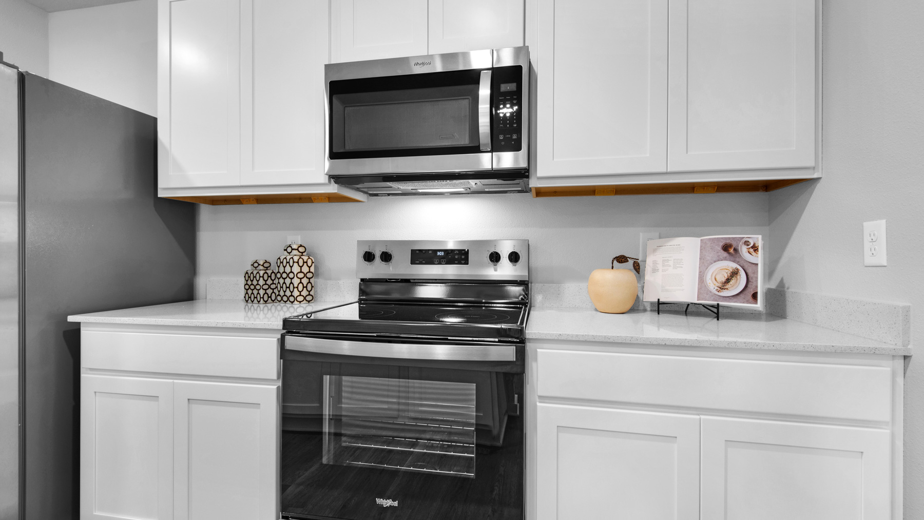 The kitchen has as stove microwave and dishwasher