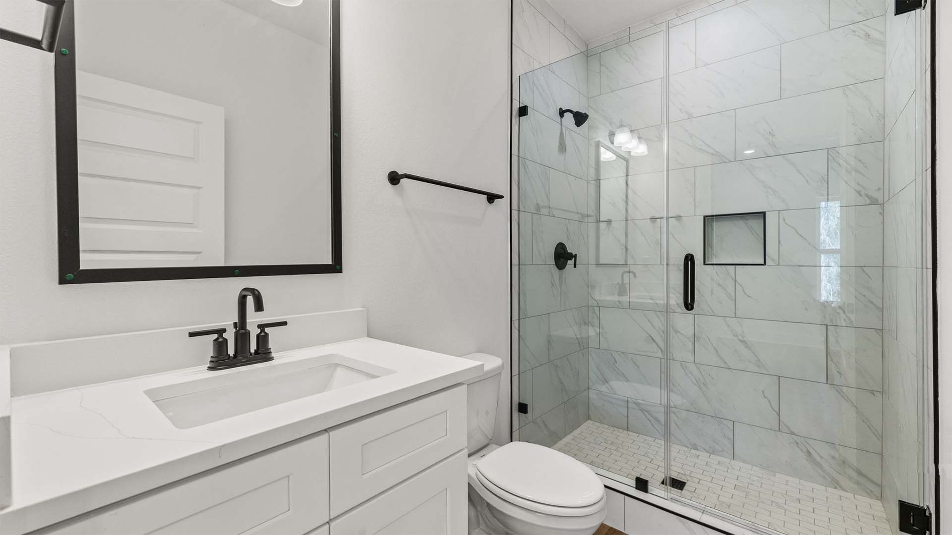 The primary bathroom has a single vanity sink with shower