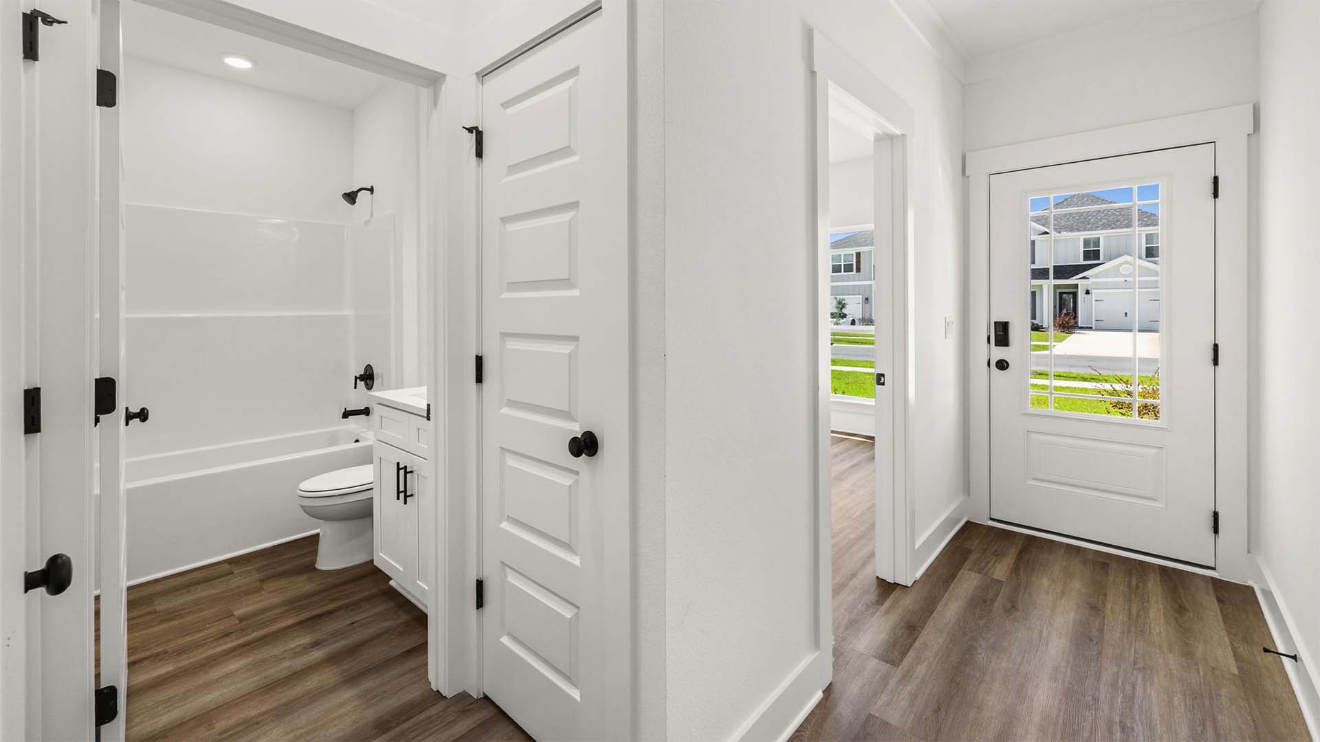 Two guest bedrooms and a shared bath are located off the foyer