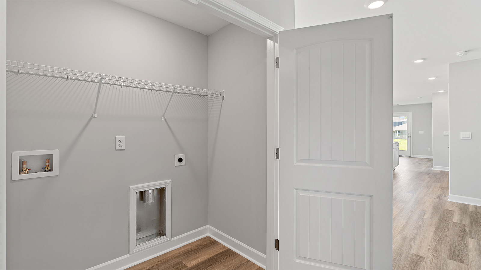 The laundry area is located off the entry hall adjacent to the kitchen