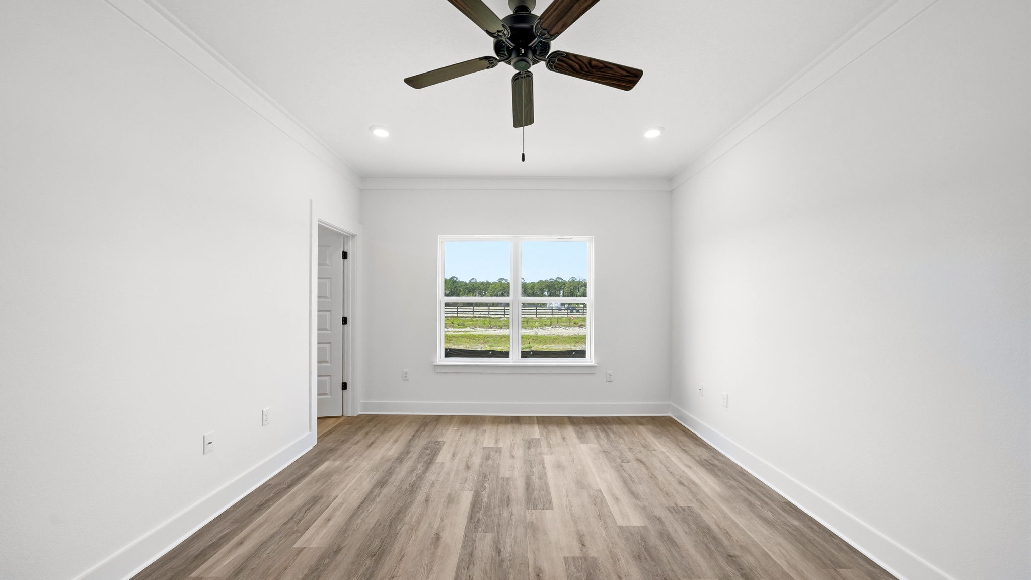 The primary bedroom has a picture window allowing for natural light