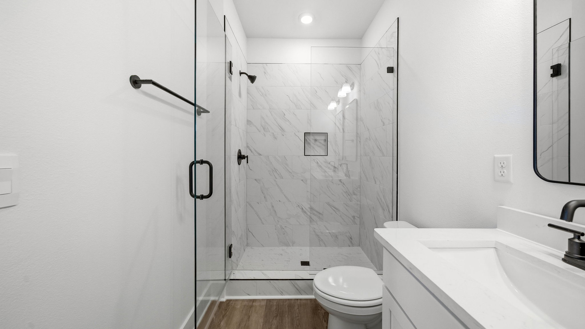 The primary bathroom has a single vanity with lower cabinetry for storage
