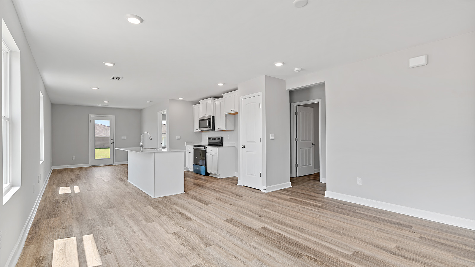 The spacious design of the main living area offers a seamless transition between the kitchen, dining and living areas