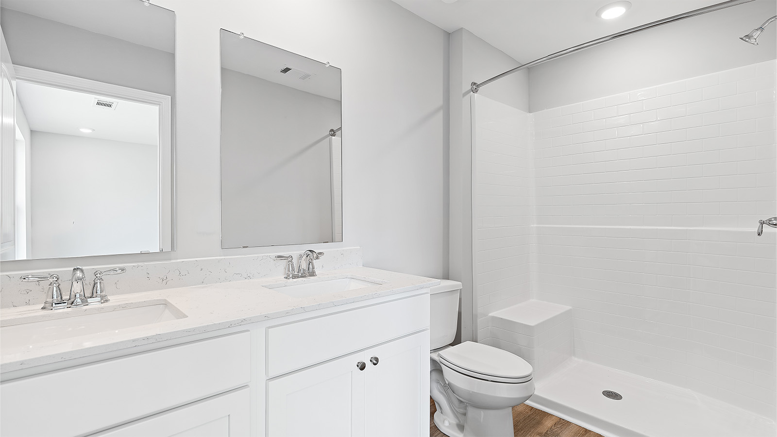 The primary bathroom has a single vanity with lower cabinetry and a shower