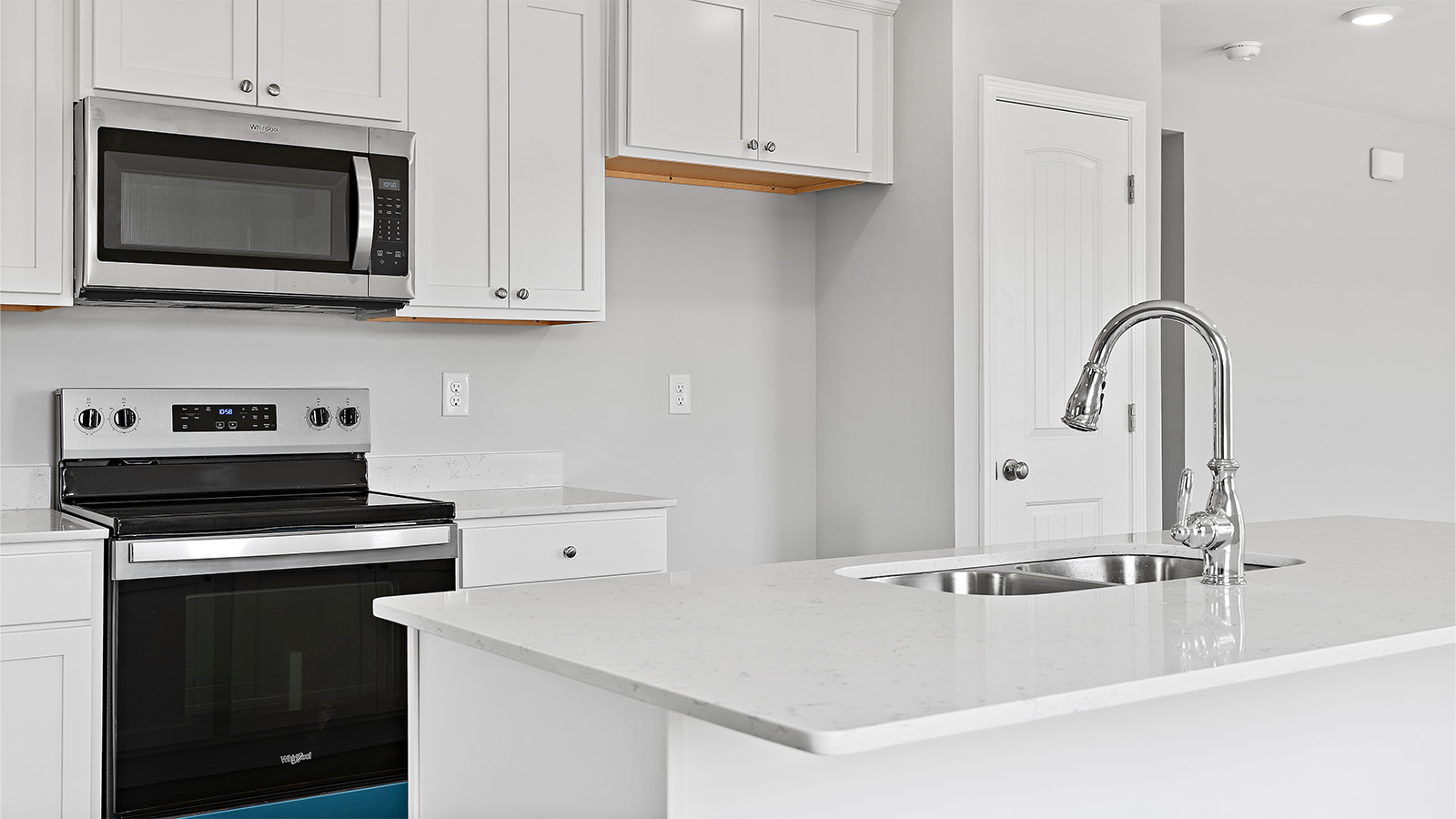 The kitchen has upper and lower cabinetry for storage