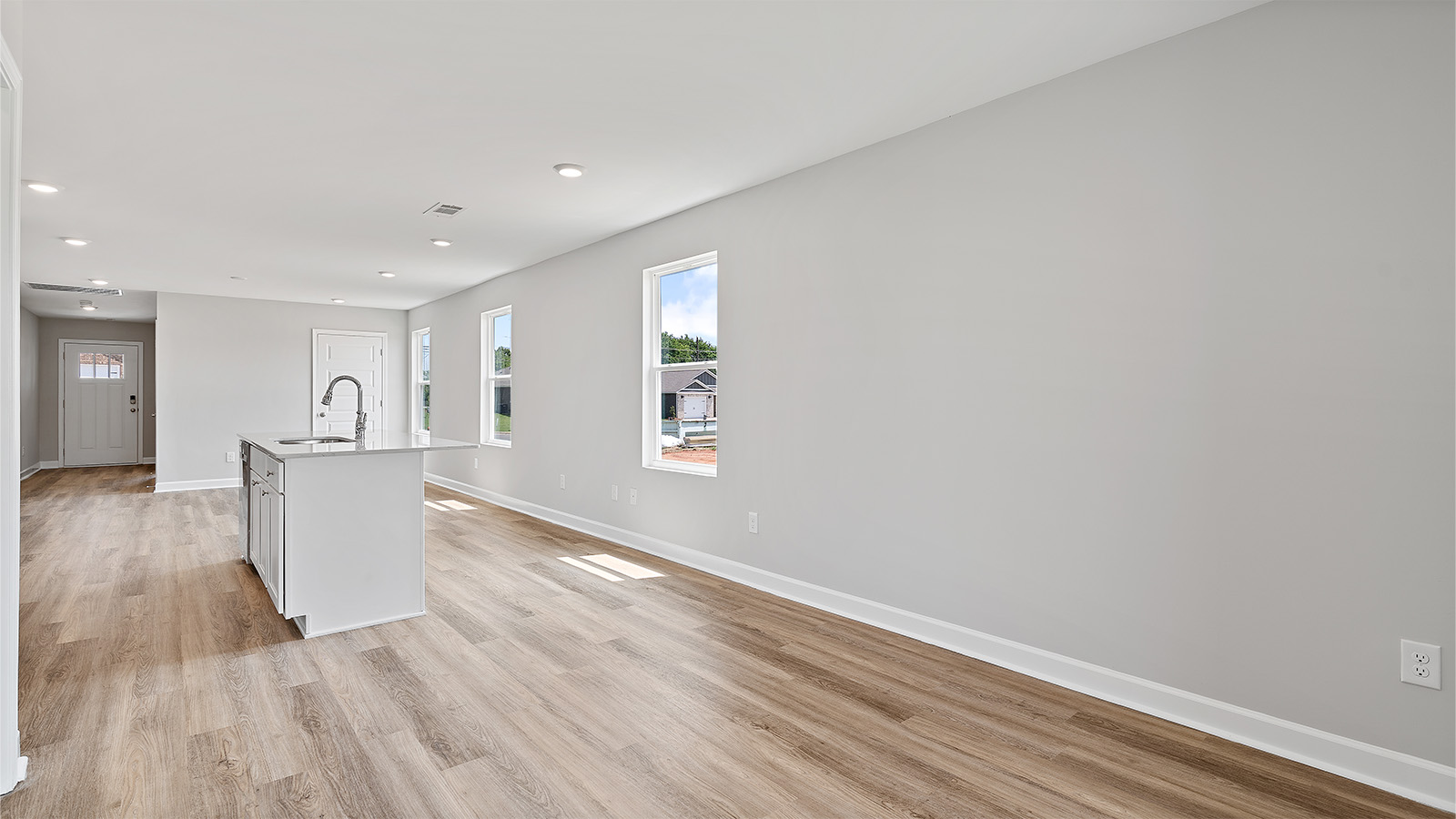There is a breakfast area or space for a bistro table near the kitchen island