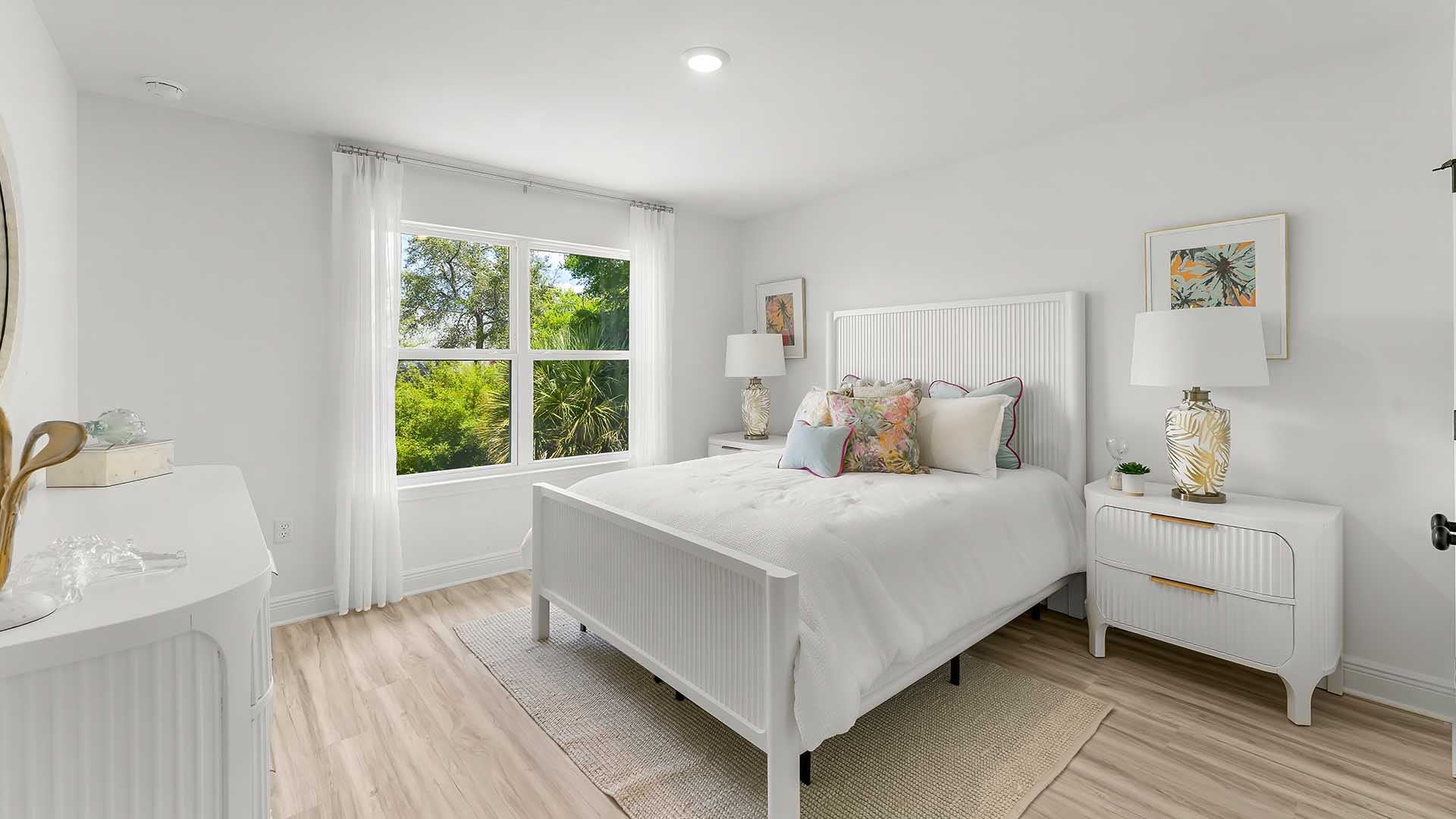 One of two guest bedrooms on the second level has a large window for natural light