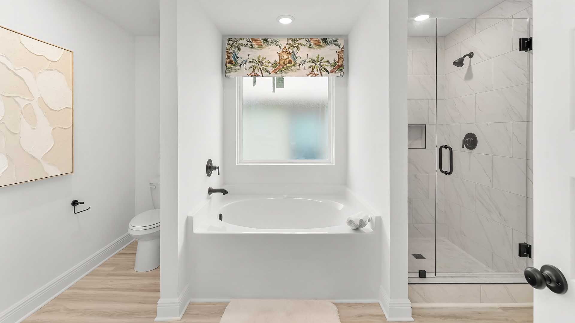 The primary bathroom offers a spa like retreat