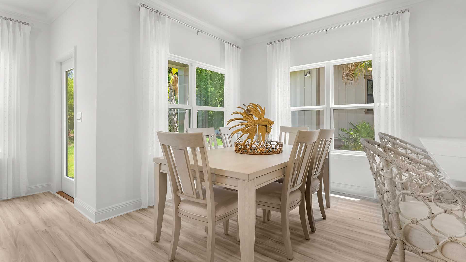 The dining area is illuminated by windows for natural light