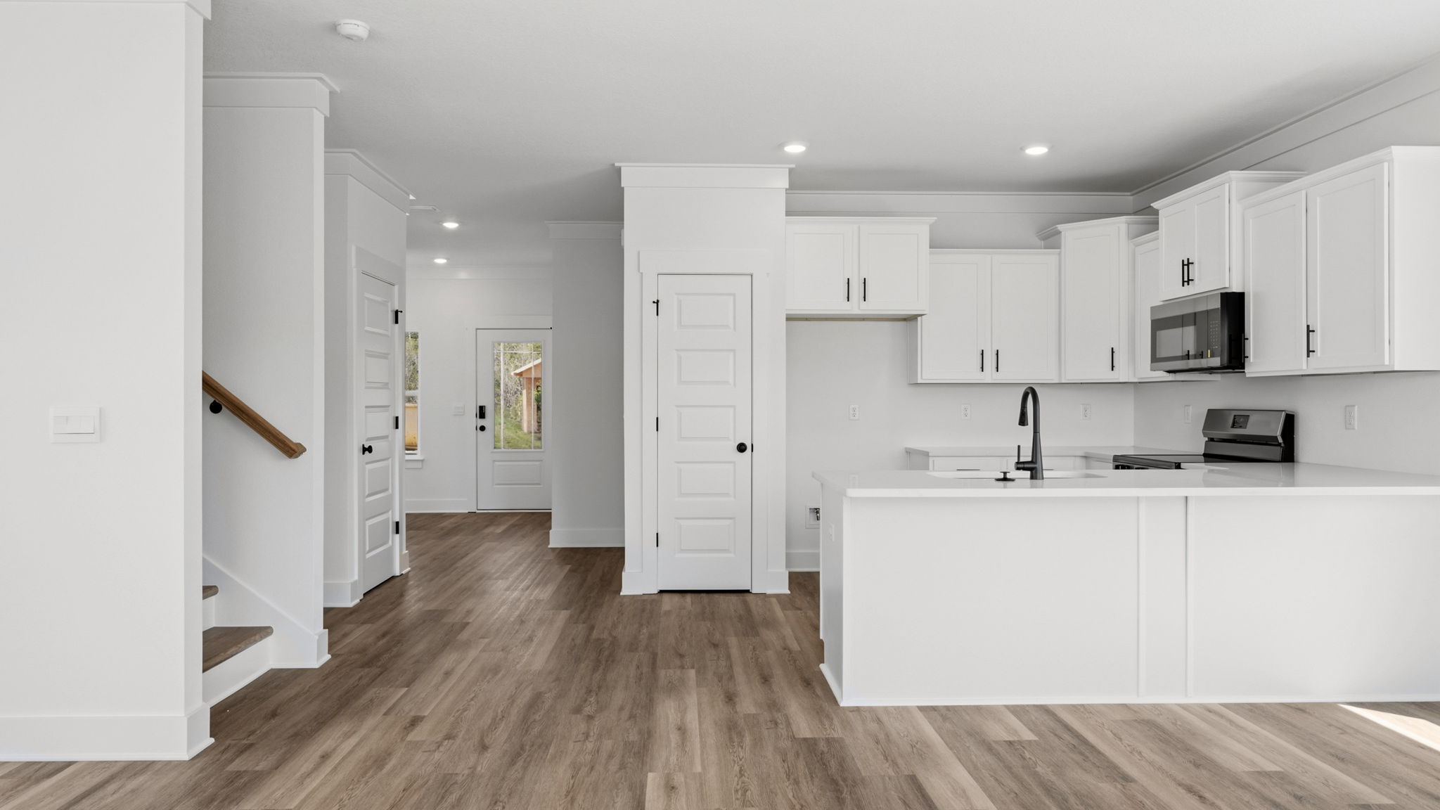 The kitchen has upper and lower cabinetry for storage