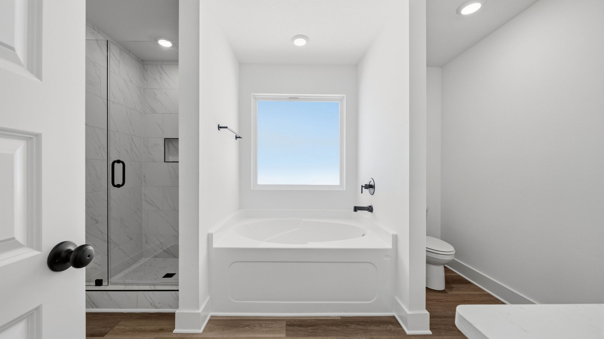The primary bathroom has a shower and separate soak tub